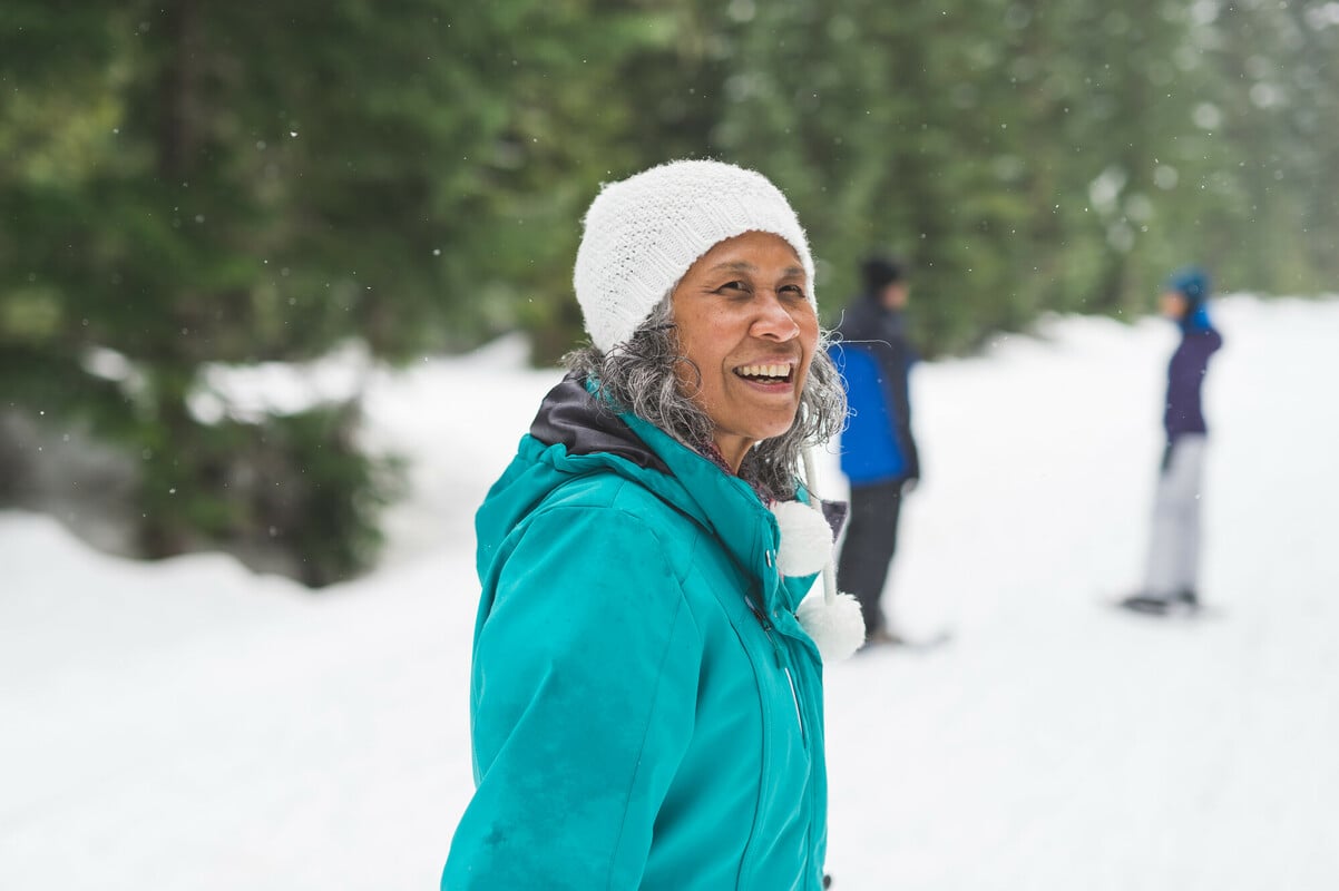 A lady wrapped up warmly in the snow